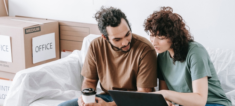 a couple looking at the laptop