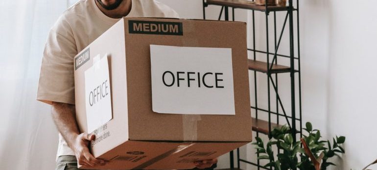 Man carrying the box with Office label