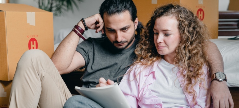 A couple writing down their moving plan