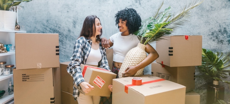 Two girls surrounded by moving boxes