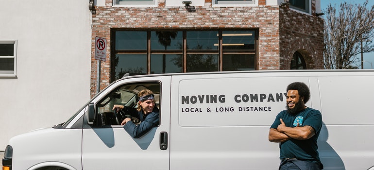 commercial movers Orange Park FL standing in front of a moving van