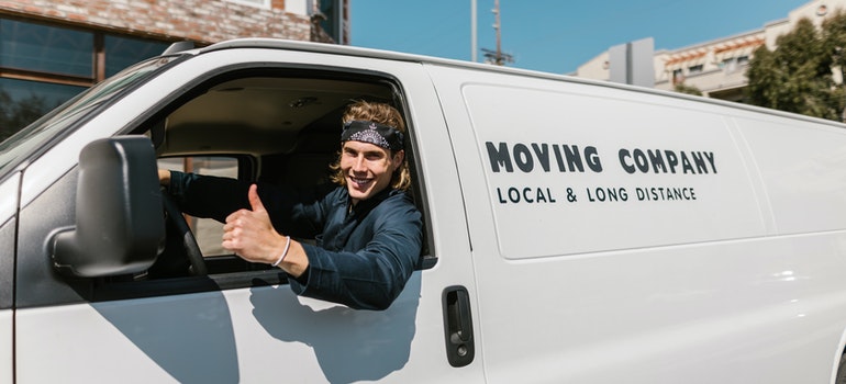 movers giving a thumbs up from a moving van