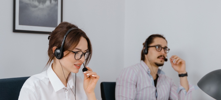 two people working in customer service talking with clients