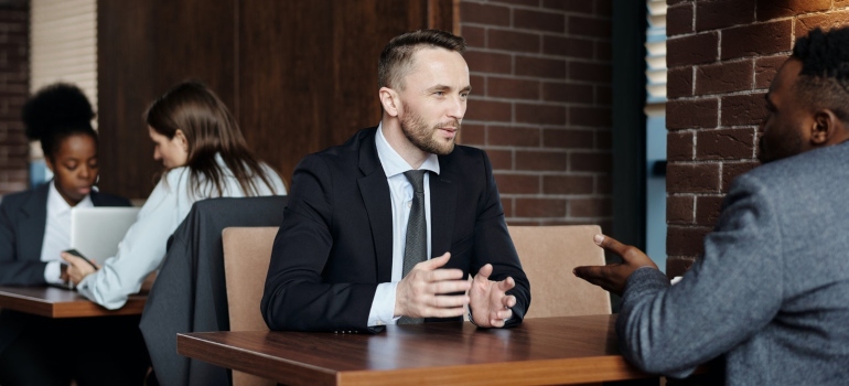 two businessmen talking about how to lease commercial real estate in Tampa