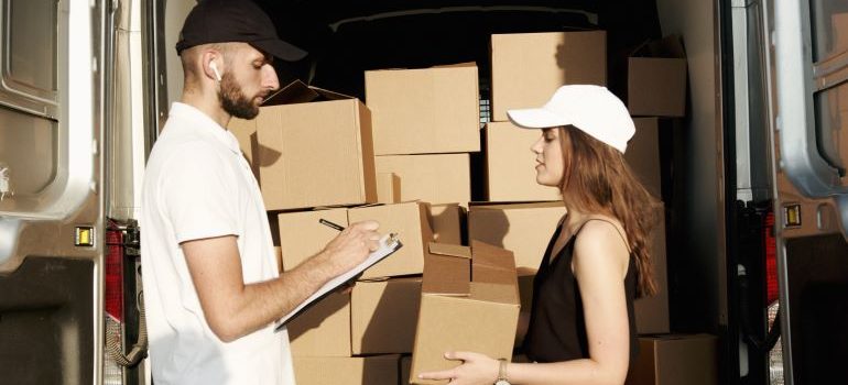 man and woman with cardboard boxes