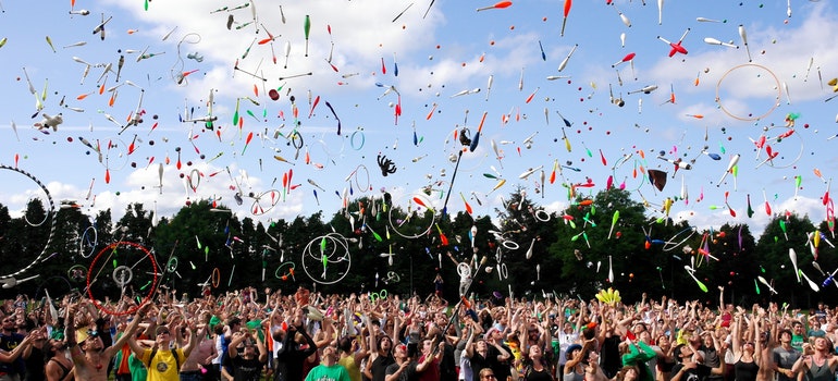 People at a festival throwing pins