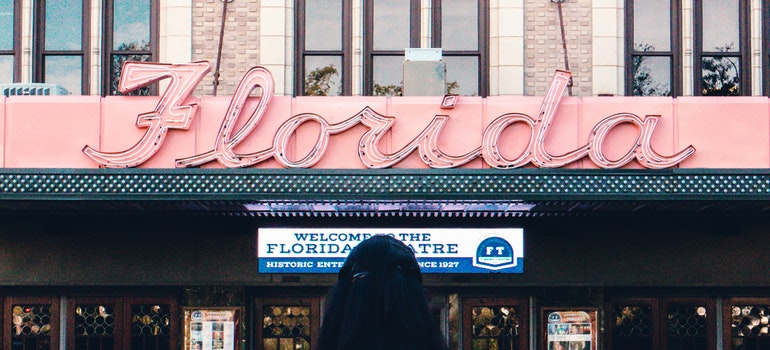 A woman in front of Florida sign