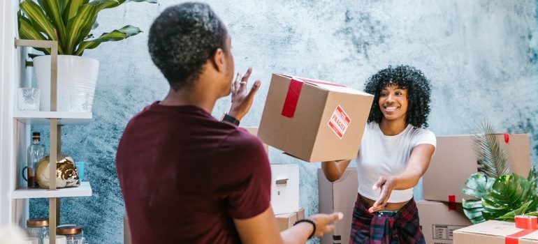 woman and man with cardboard boxes