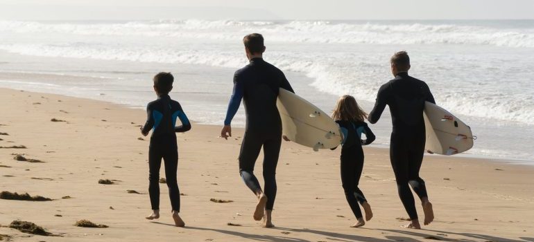 Family of surfers on the beach 