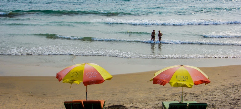 Umbrellas and two people on a beach