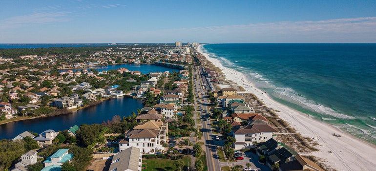 Aerial View of Houses Near A Beach Under Blue Sky - moving to Hallandale Beach FL.