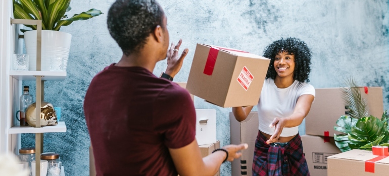 Man and woman packing boxes