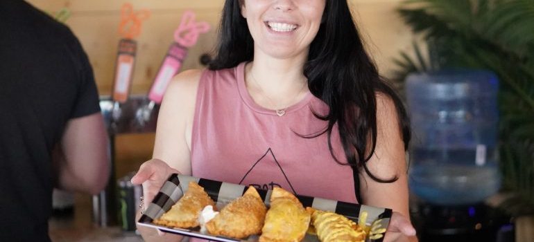 Woman holding a plate with pastries 