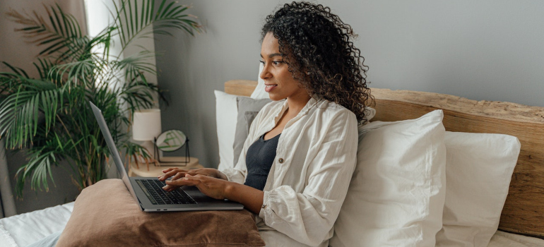 A woman using a laptop.