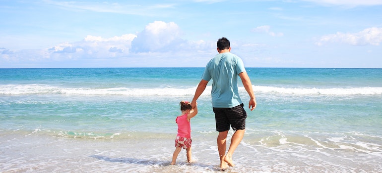 a father and a daughter at the beach