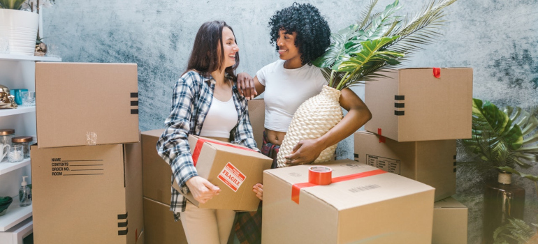 Two women packing for a move.