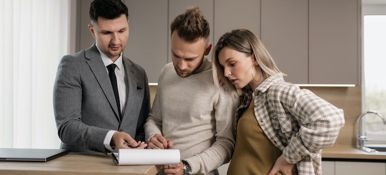 A real estate agent showing a house to a couple