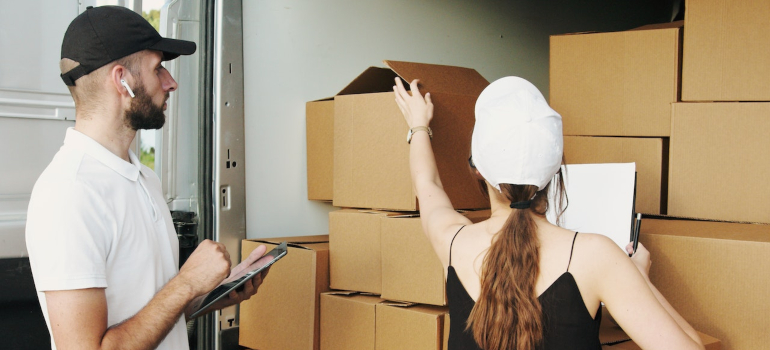 Man and woman organizing moving boxes