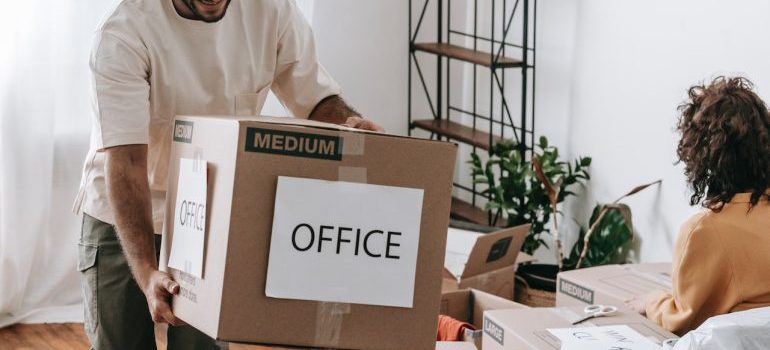 Man carring a box with label 