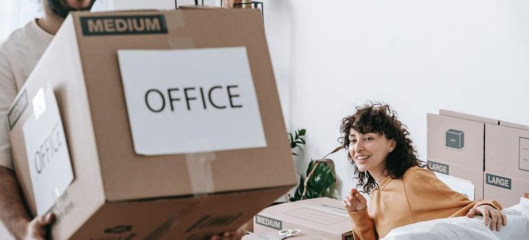 Man and woman moving an office