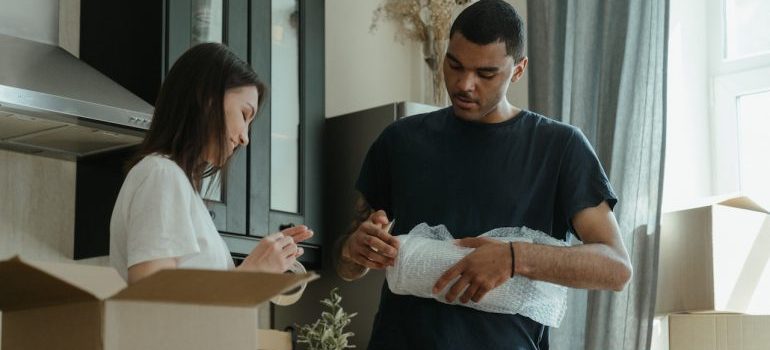 Couple packing for the move and overcoming one of the biggest challenges of moving locally in Miami 