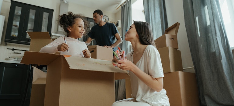 family packing and waiting for long distance movers Cedar Grove FL to arrive