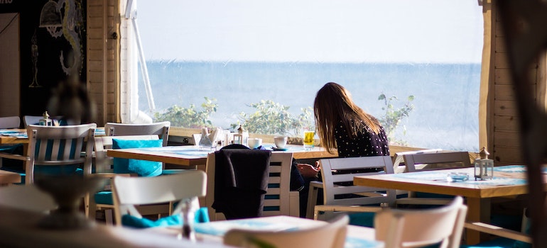 Woman Sitting on Chair With View of Sea.