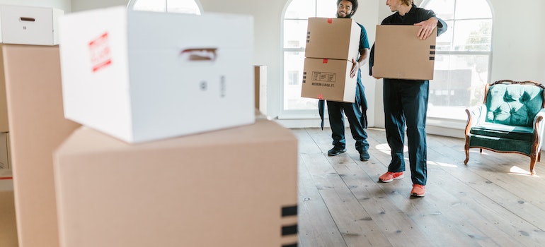 Movers carrying moving boxes