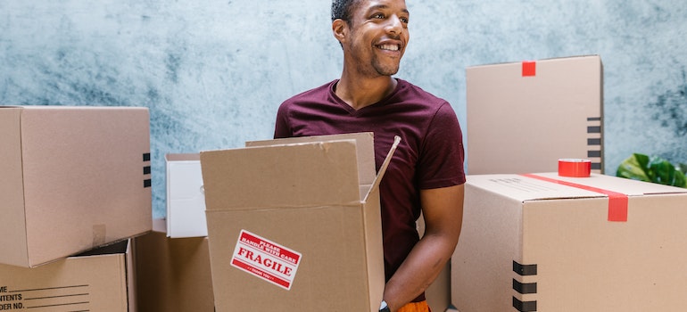 A mover carrying a moving box