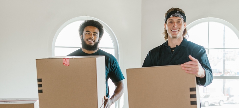two commercial movers Silver Lake FL residents love, holding moving boxes
