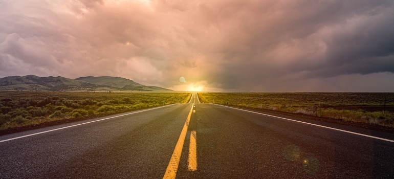 a road showing How many miles is considered a long-distance move