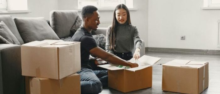 A couple packing boxes for a long distance move.