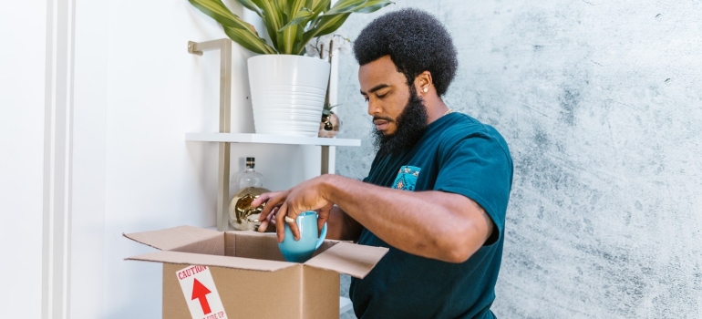 A mover packing a mug