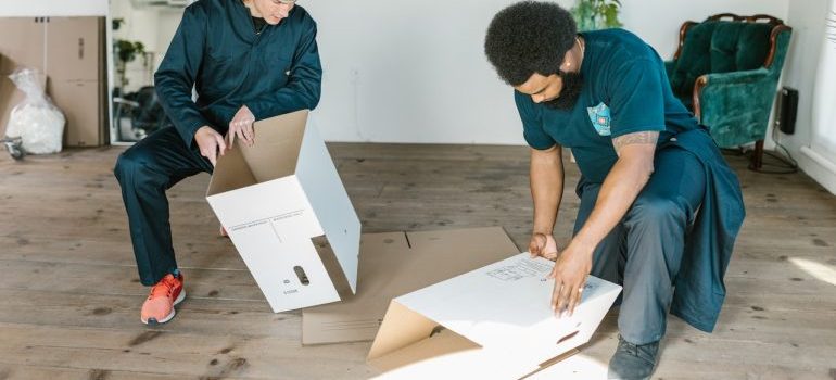Professional packers making a boxes for your moving