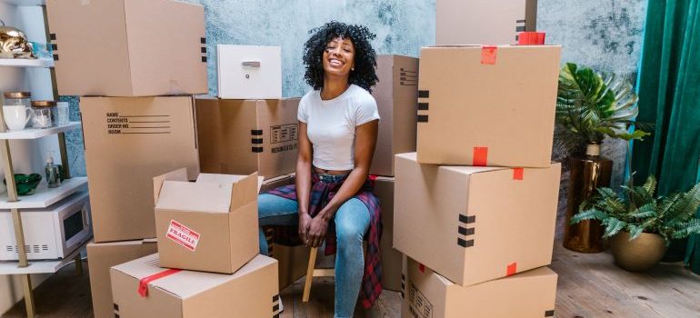 woman surrounded by moving boxes