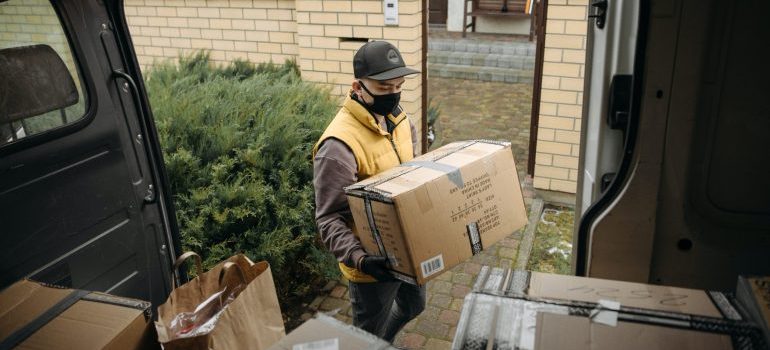 A man holding and loading boxes