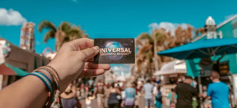 a person holding Universal card