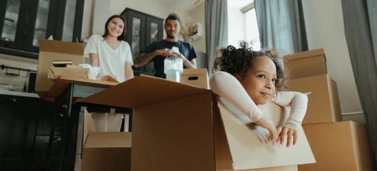 a child playing with leftover moving boxes