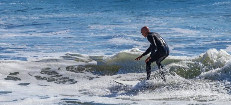 Man surfing in the best Florida cities with most sports opportunities
