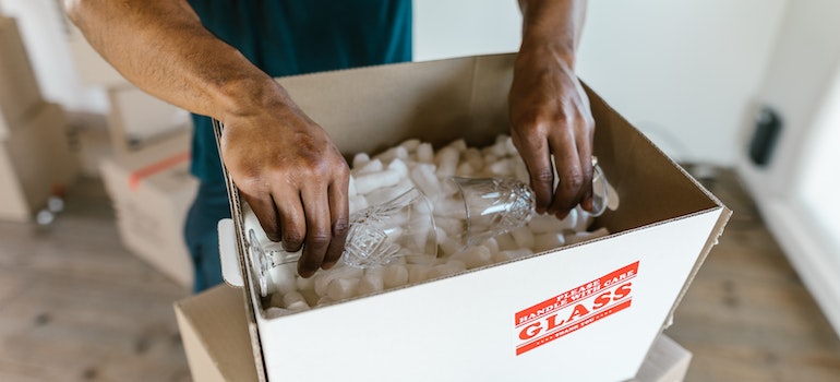 Man packing something in the box.