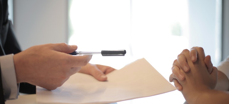 Businessman giving a contract to a client to sign