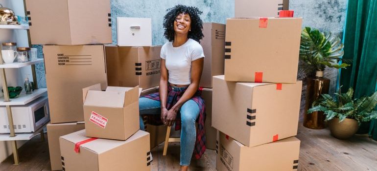 woman surrounded by moving boxes