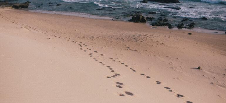 A beach with footsteps imprinted on it