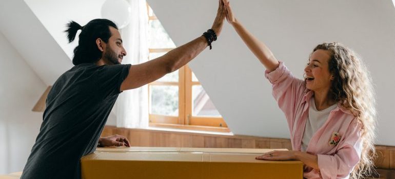 A happy couple giving high five to each other