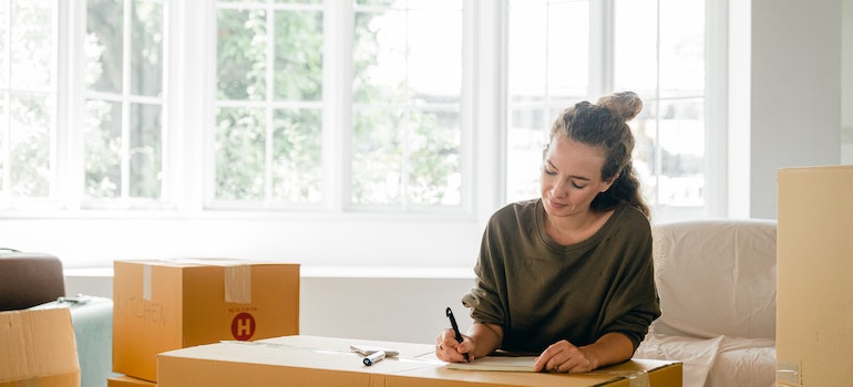 Woman labelling boxes