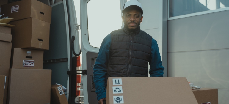 mover unloading the truck and driving the box on a trolley