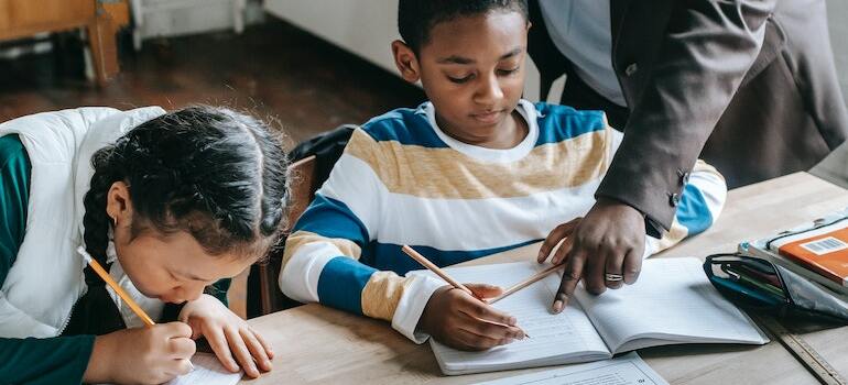 A teacher helping their students