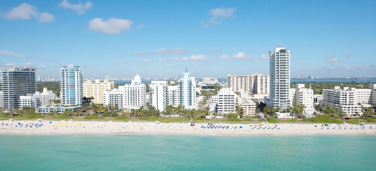 A photo of a beach and buildings in the background you can enjoy after moving from Tampa to Miami