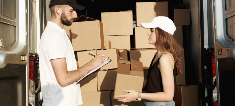 A man and a woman exchanging free packing supplies