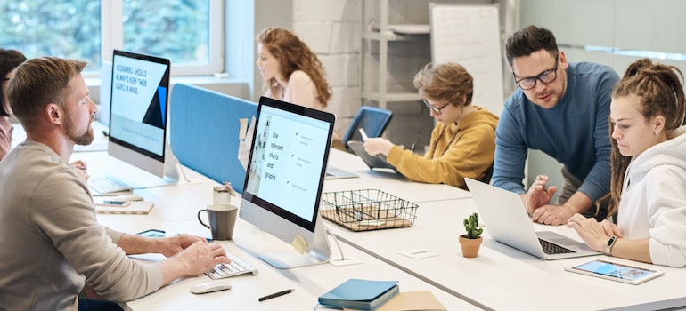 Office space with people working at the big table